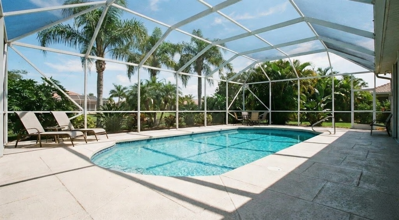 Professional pool technician skimming leaves from swimming pool in Ocala, Florida